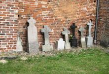 Gravestones Against Church Wall